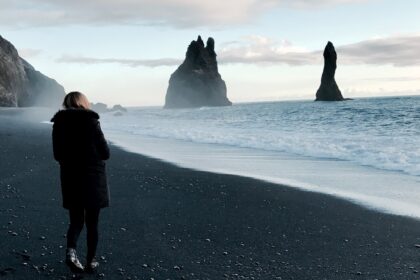 person walking near body of water