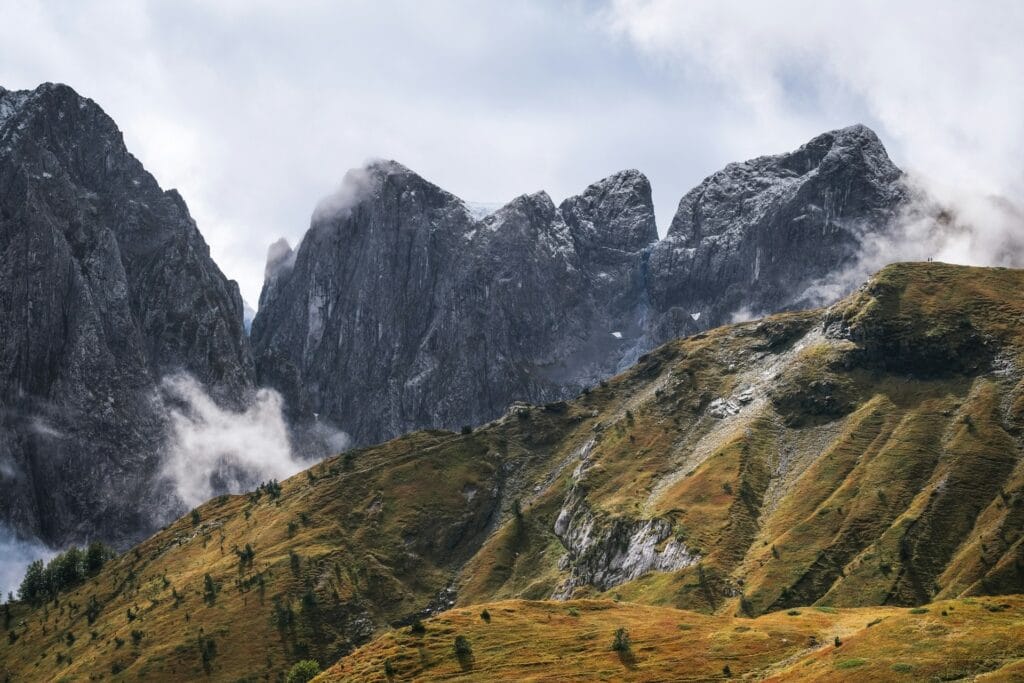 The mountains are covered in clouds and grass