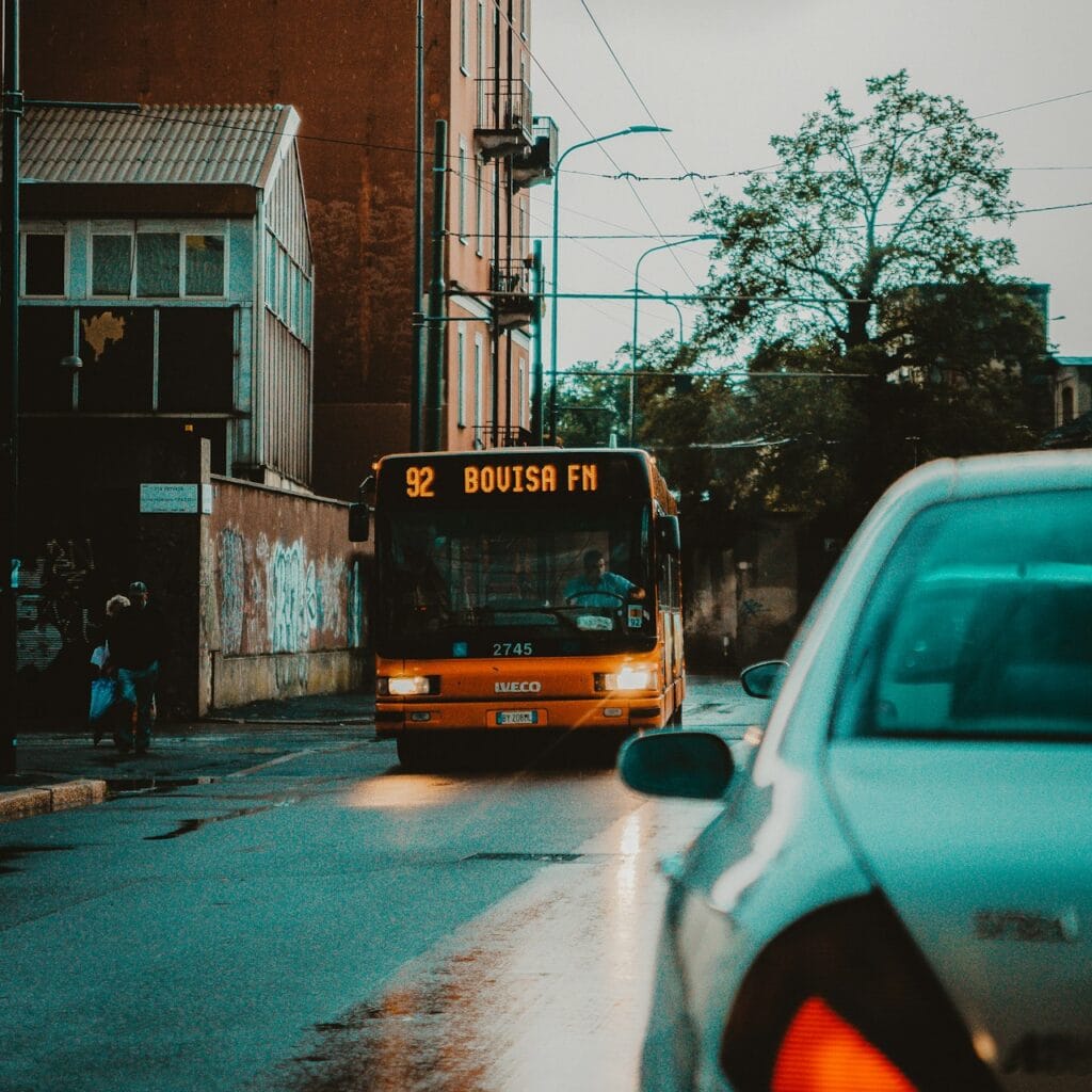 orange bus in road during daytime close-up photography