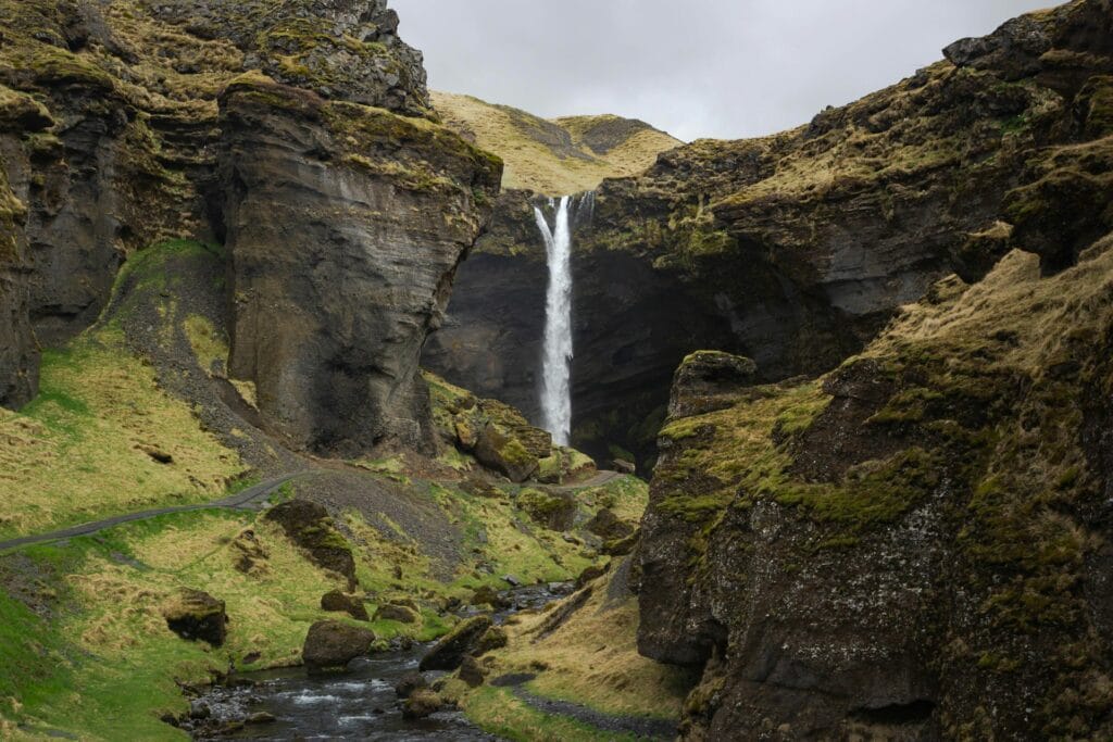 A small waterfall in the middle of a mountain