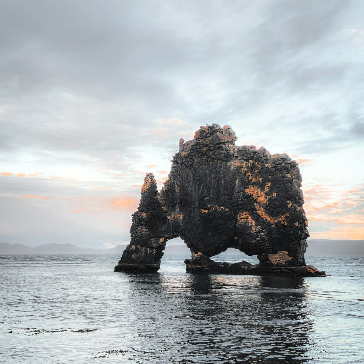 a rock formation in the middle of a body of water