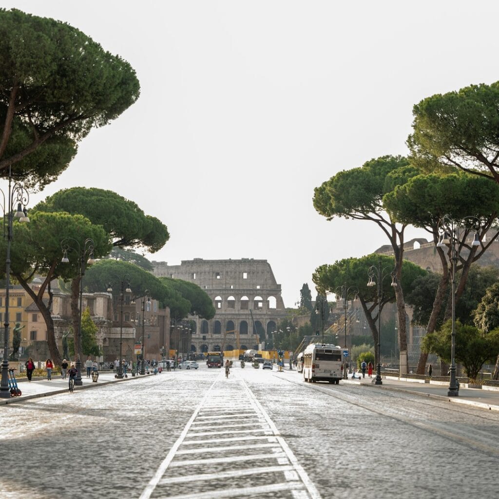 a street lined with trees and a building in the background