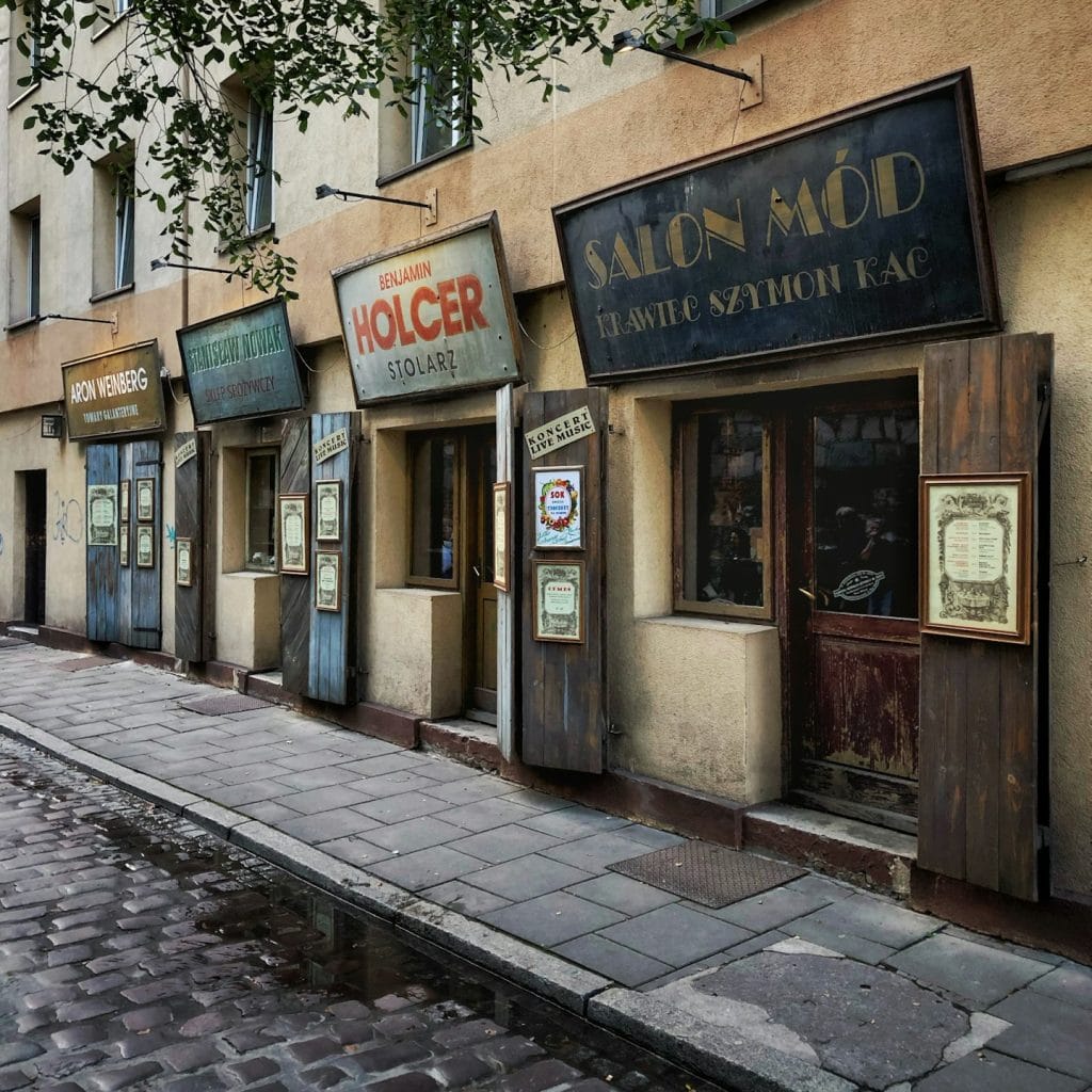 Kazimierz, Kraków concrete sideways beside store facades