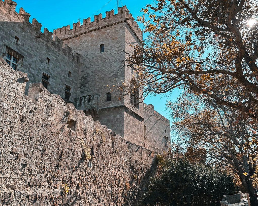 a stone castle with a clock on the side of it