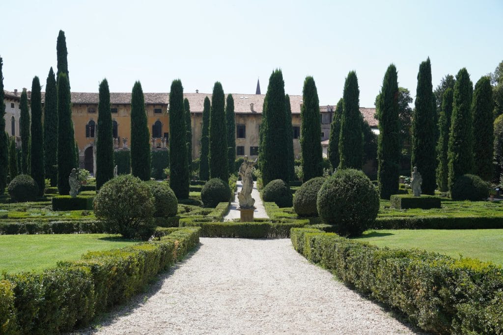 Giardino Giusti  A large building with a long driveway in front of it