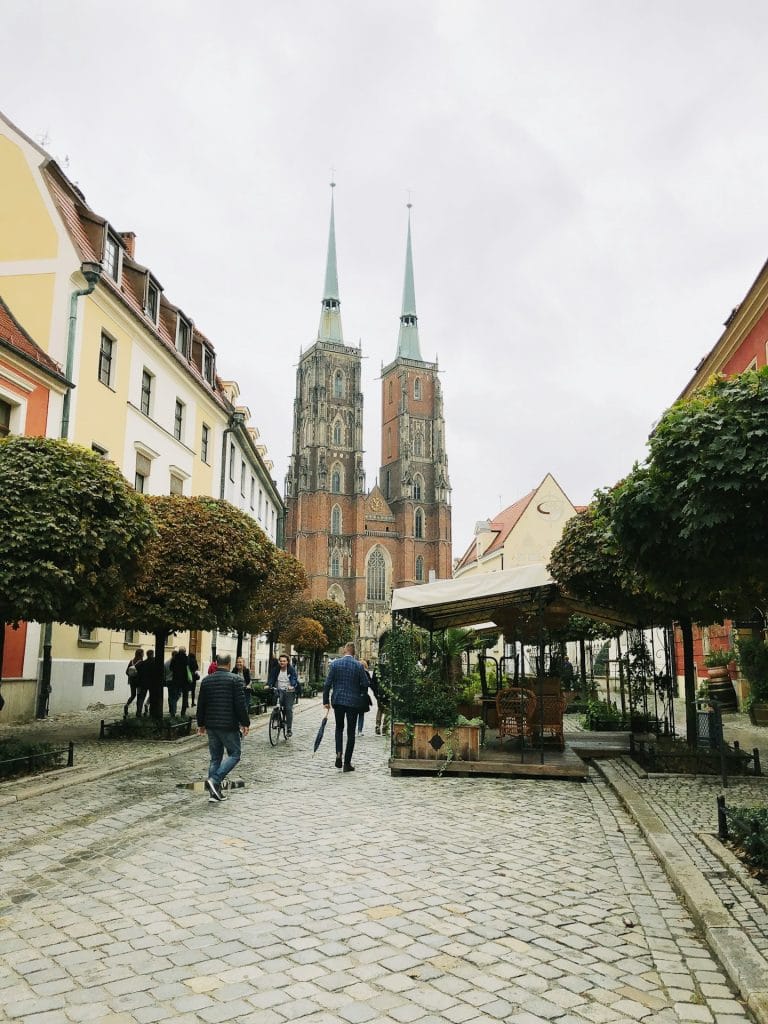 Ostrów Tumski, Wrocław, people standing on walkway near buildings