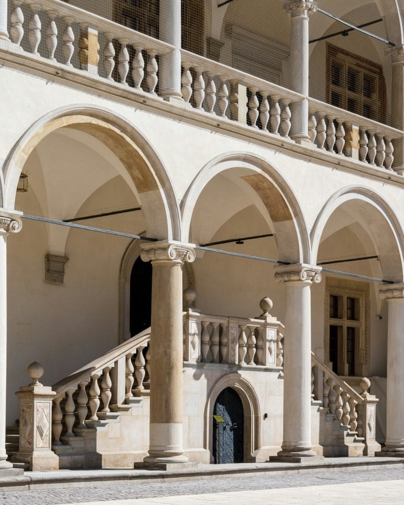 Wawel, Kraków a large building with a bunch of pillars and arches