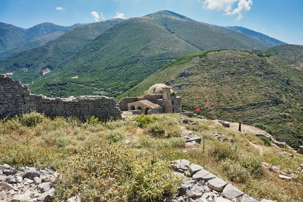 A view of a mountain with a house on top of it