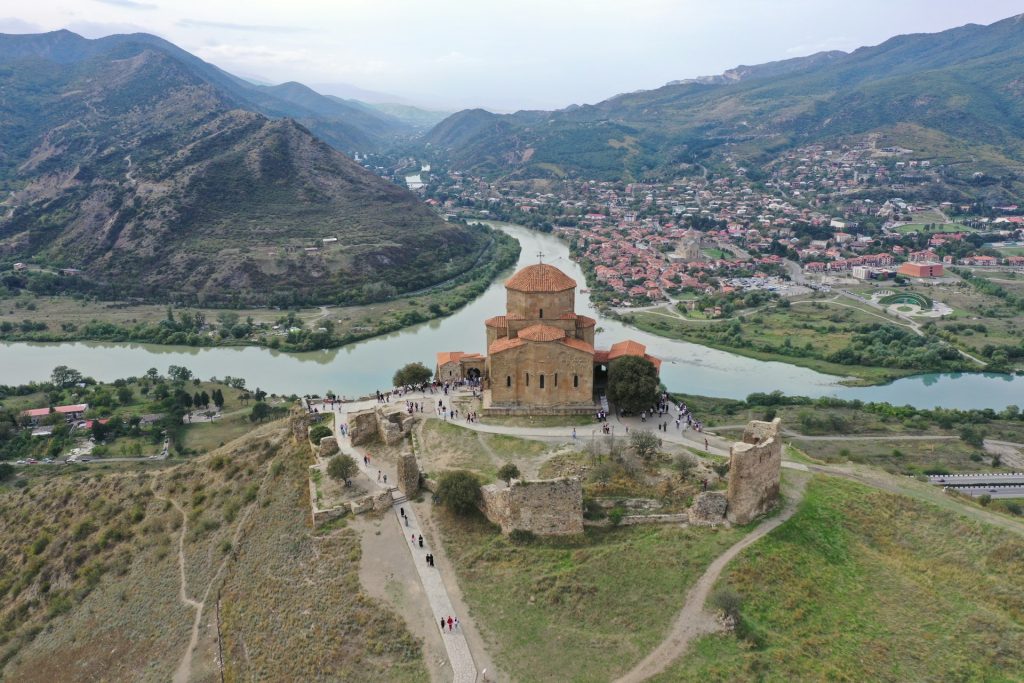 aerial view of brown concrete building near body of water during daytime