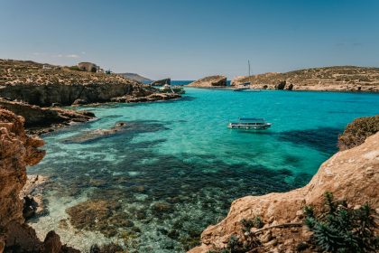 a boat is in the clear blue water