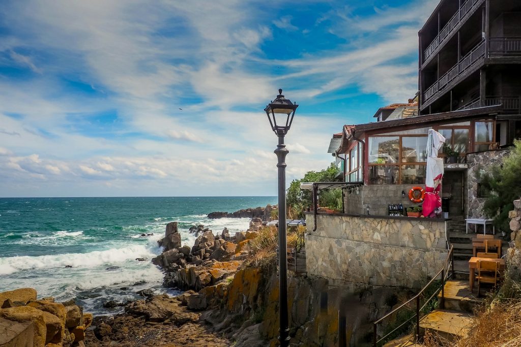 a street light sitting next to the ocean