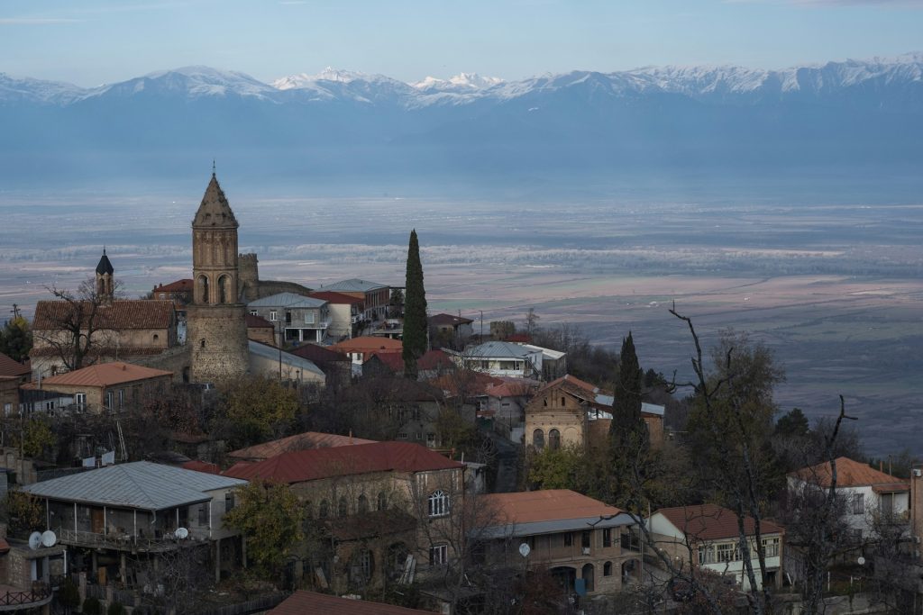 a small town with a mountain in the background