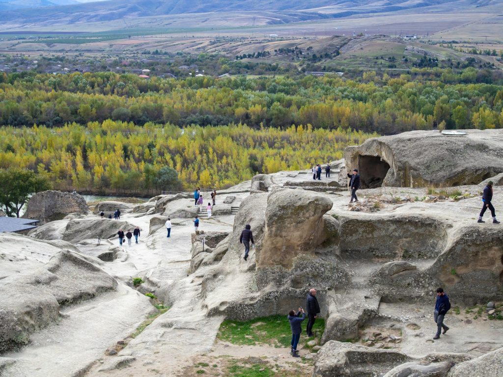 A group of people standing on top of a rock formation