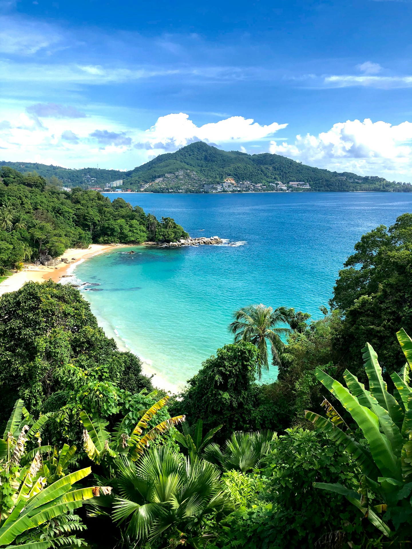 a view of a tropical beach from a hill