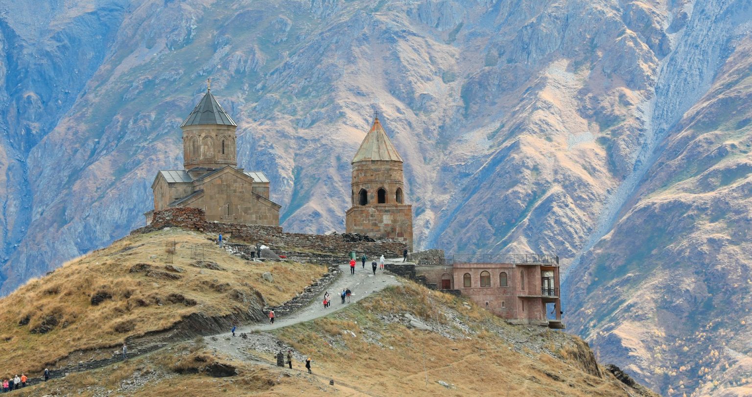 brown castle near rock formation during daytime