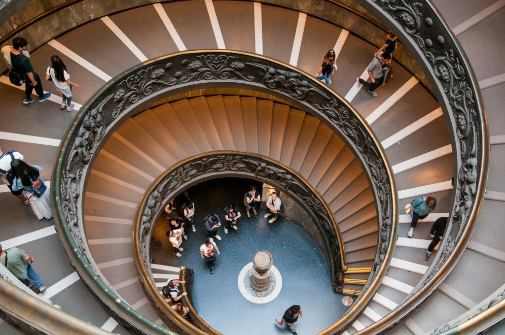 people walking on spiral staircase