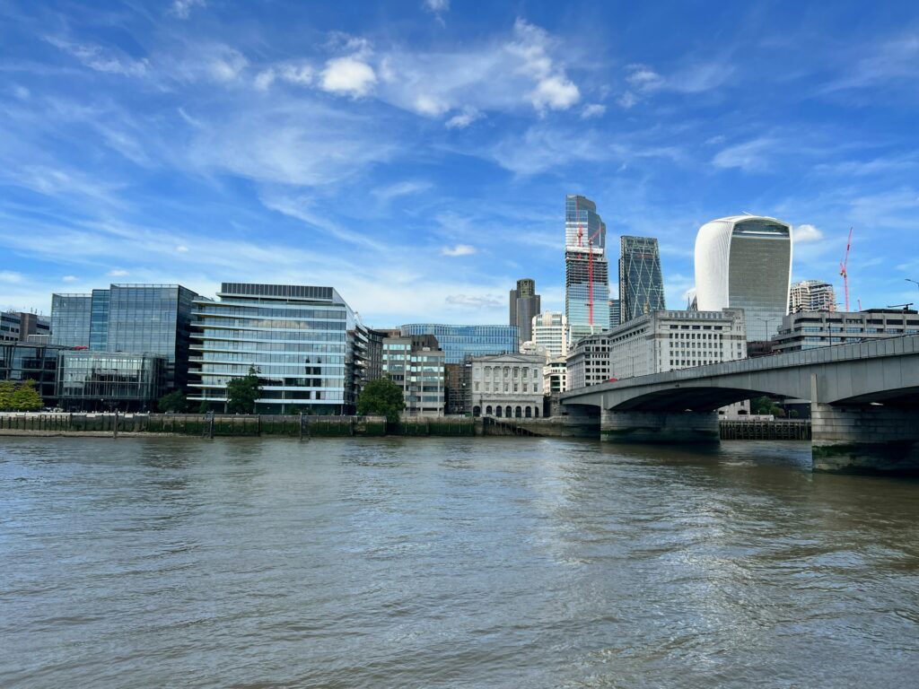 a bridge over a river with buildings in the background