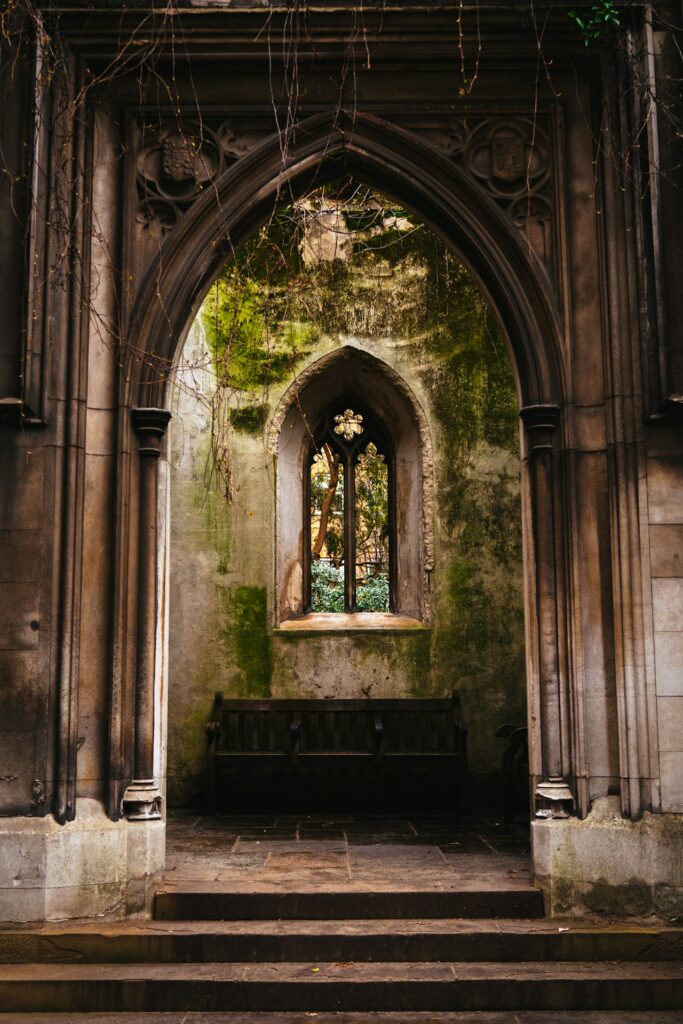 an old church with a stone alter and a stained glass window