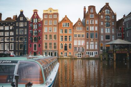 a row of buildings next to a body of water