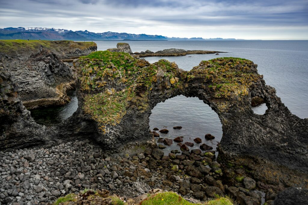 A rock formation on the shore of a body of water